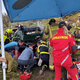 (FOTO) Ustavil se je po 15 metrih prevračanja: Pod traktorjem ukleščen 65-letni domačin, pod prikolico krave